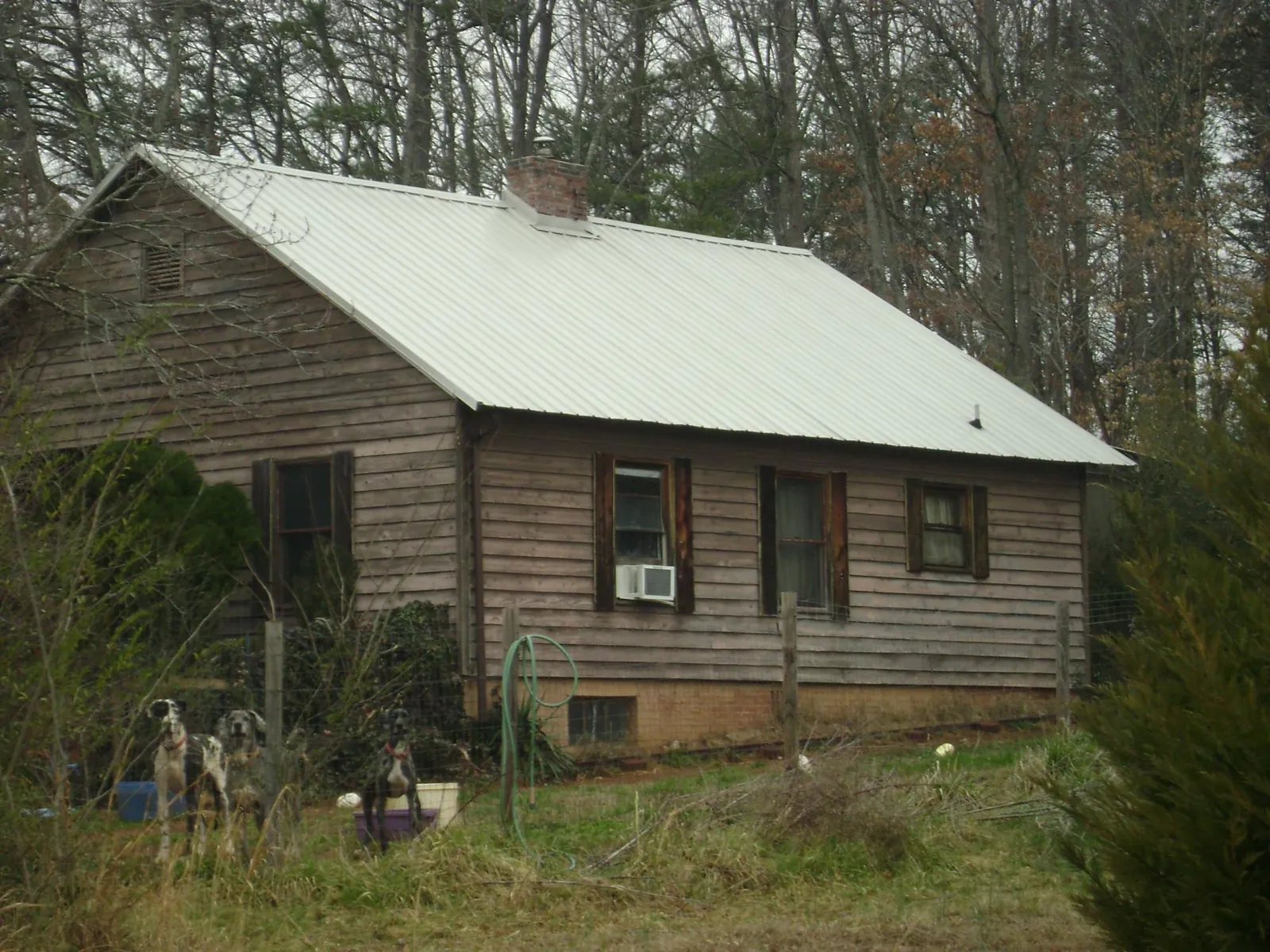 White metal roof on an old wood sided farmhouse, from a Metal Roof Installation job in New London